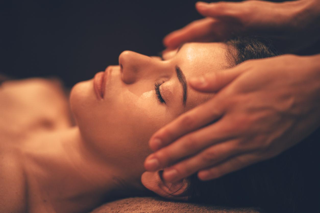 Young woman getting head massage at day spa salon istock 913090502
